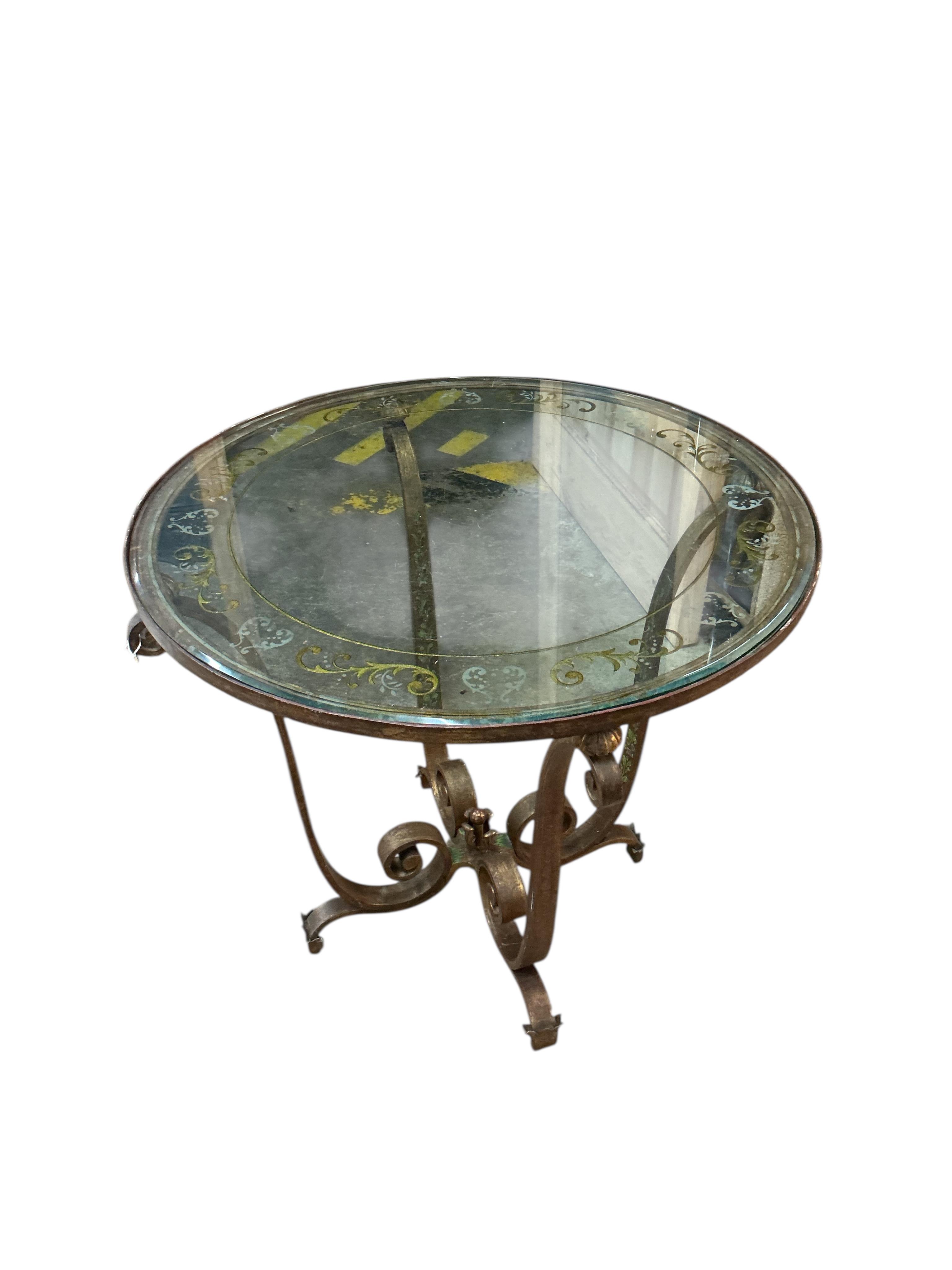 In the manner of Raymond Subes, a circular engraved glass and patinated wrought iron occasional table, diameter 70cm, height 62cm